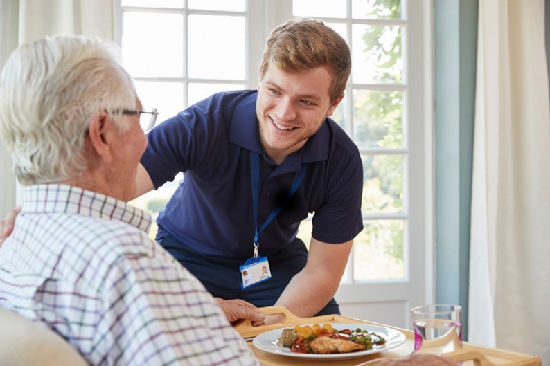 home care franchise, man helping elderly man