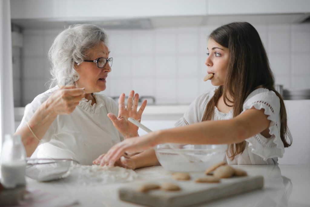 home care franchise business, Photo by Andrea Piacquadio: https://www.pexels.com/photo/pensive-grandmother-with-granddaughter-having-interesting-conversation-while-cooking-together-in-light-modern-kitchen-3768146/