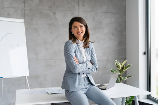 A confident businesswoman standing in a modern office, symbolizing the rise of global entrepreneurs choosing the U.S. home care industry as their preferred business venture.