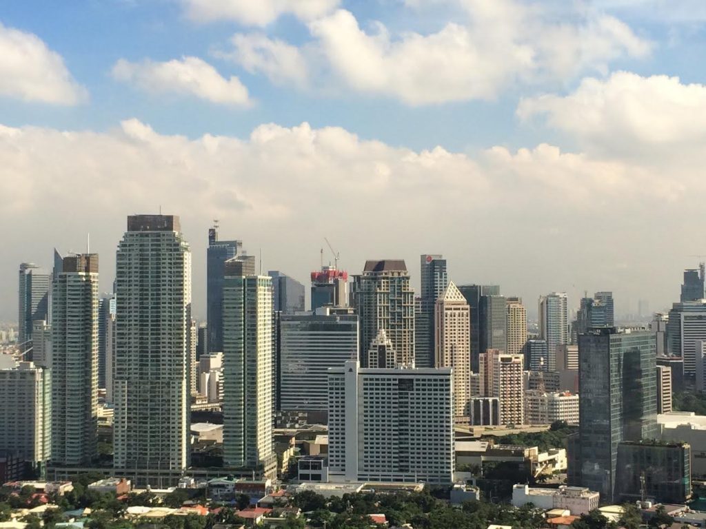 Skyline view of a bustling metro with high-rise buildings, representing the challenges and opportunities of owning a home care franchise in a competitive urban market."
