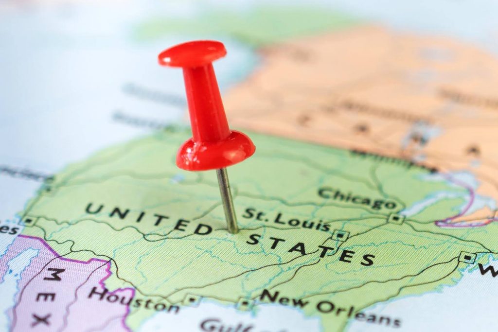 Map of the United States with a red pushpin marking a location near St. Louis, representing franchise territory planning and retirement community coverage.