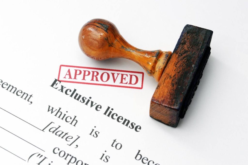 Ace Home Care Franchise state licensing approval process shown with an approved stamp on official documents, representing the licensing steps new franchise owners complete.