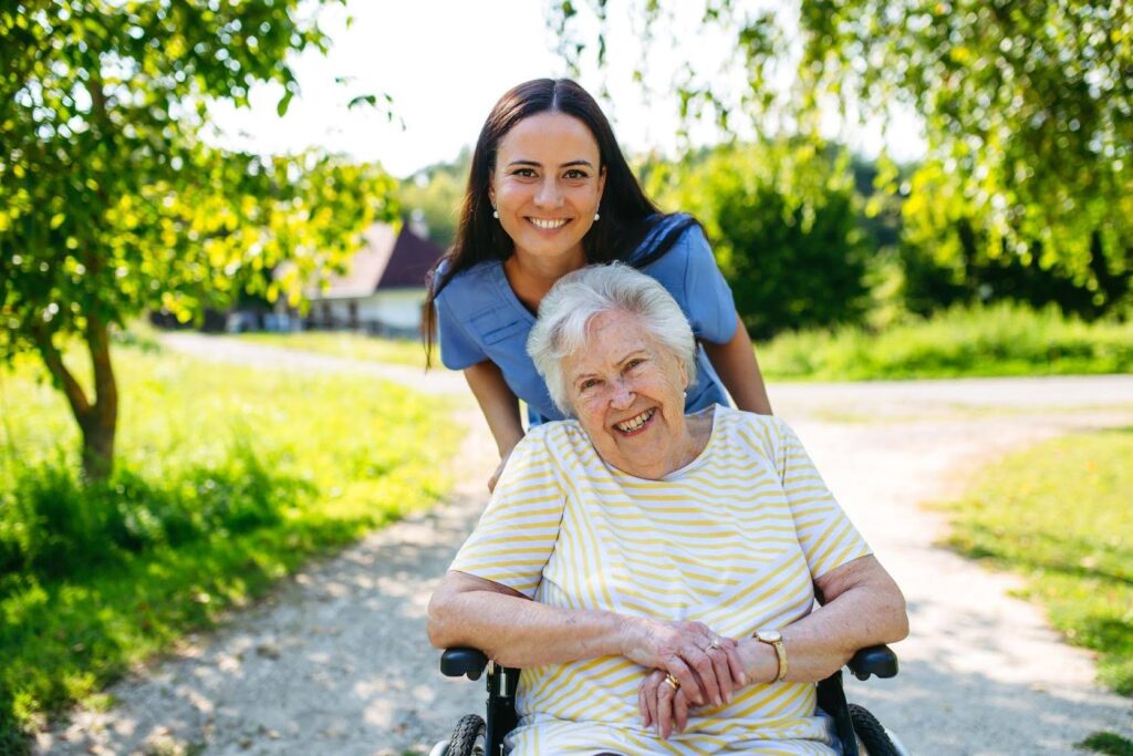 Caregiver assisting a smiling senior outdoors as Ace Home Care Franchise highlights how purpose-driven businesses create long-term stability