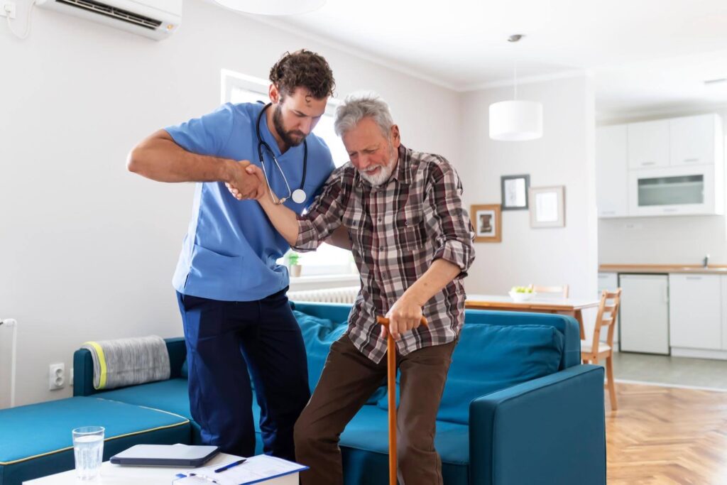 Caregiver assisting a senior at home during a family crisis with support from Ace Home Care Franchise