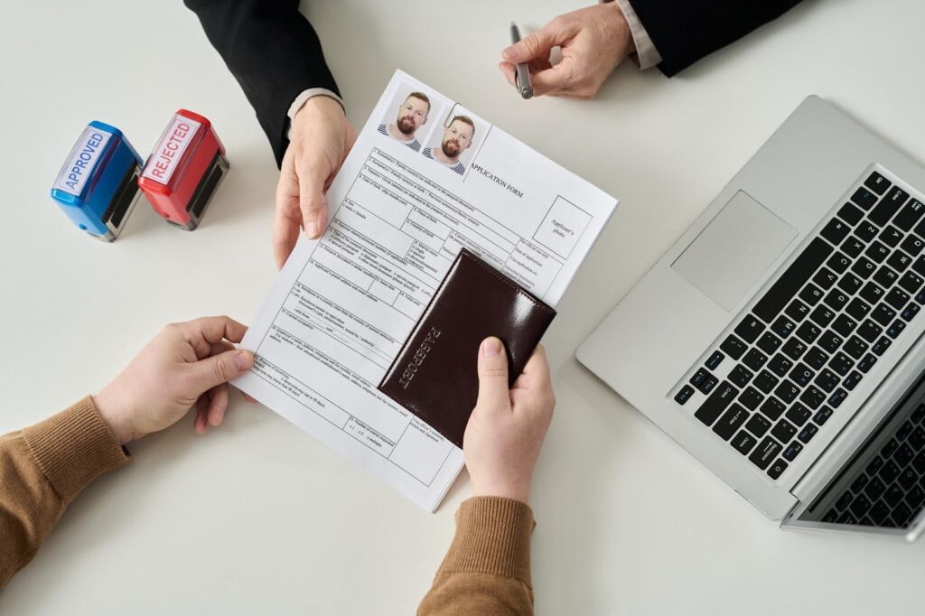 Prospective franchise owner reviewing E-2 visa application documents while exploring an Ace Home Care Franchise opportunity in the home care industry