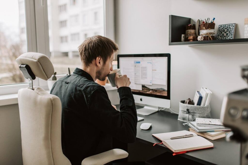 Aspiring entrepreneur working from a home office while researching how to start a home care franchise without prior business experience through Ace Home Care Franchise