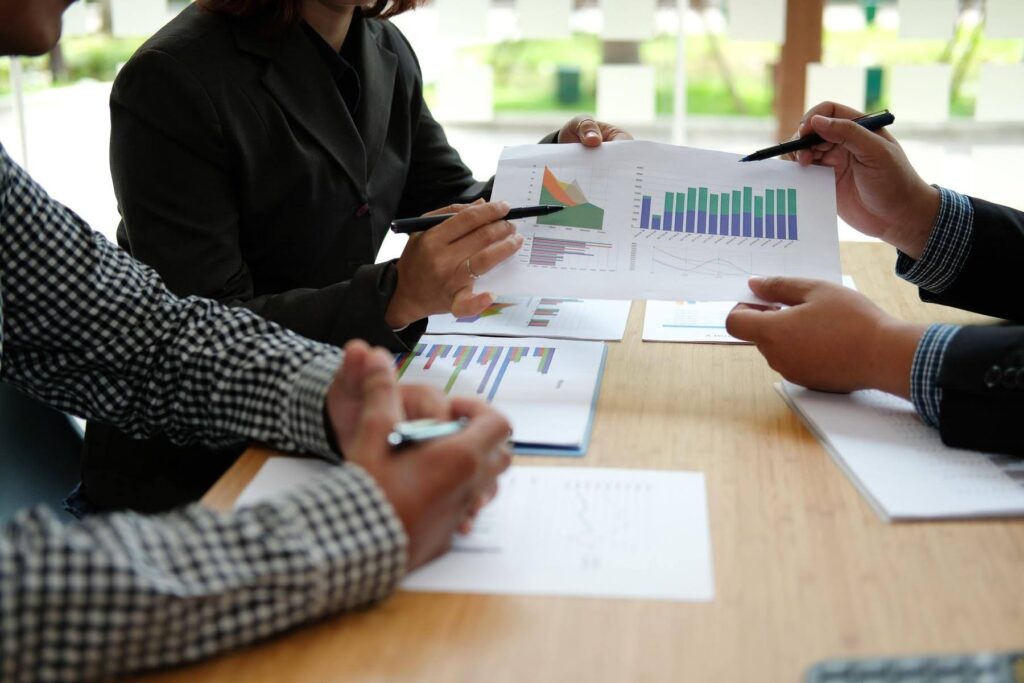 Business professionals reviewing market data as Ace Home Care Franchise explains why the home care industry is a strong opportunity for E2 visa investors