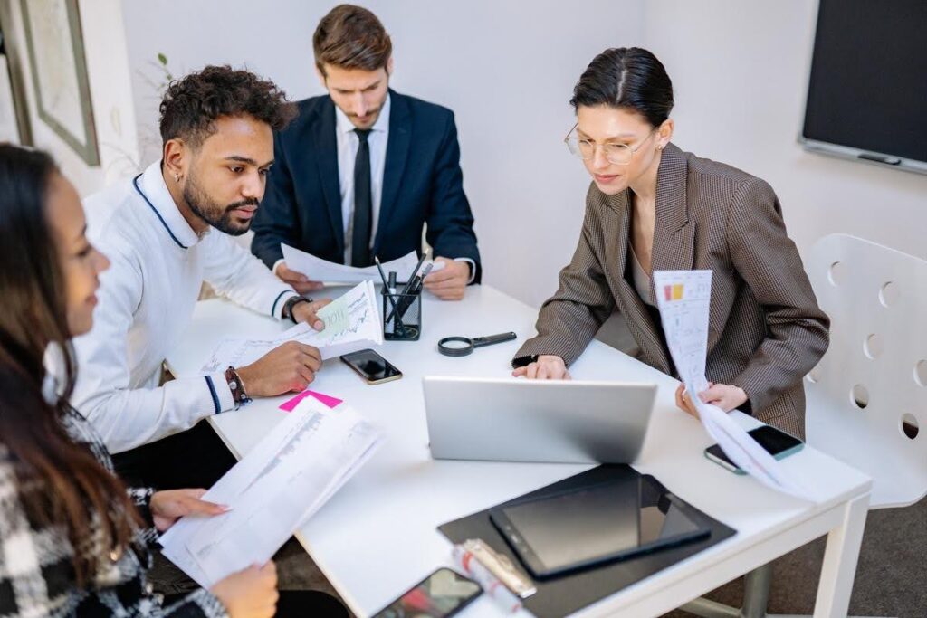 Business professionals reviewing workflows and team processes as Ace Home Care Franchise explains learning operations without previous healthcare experience