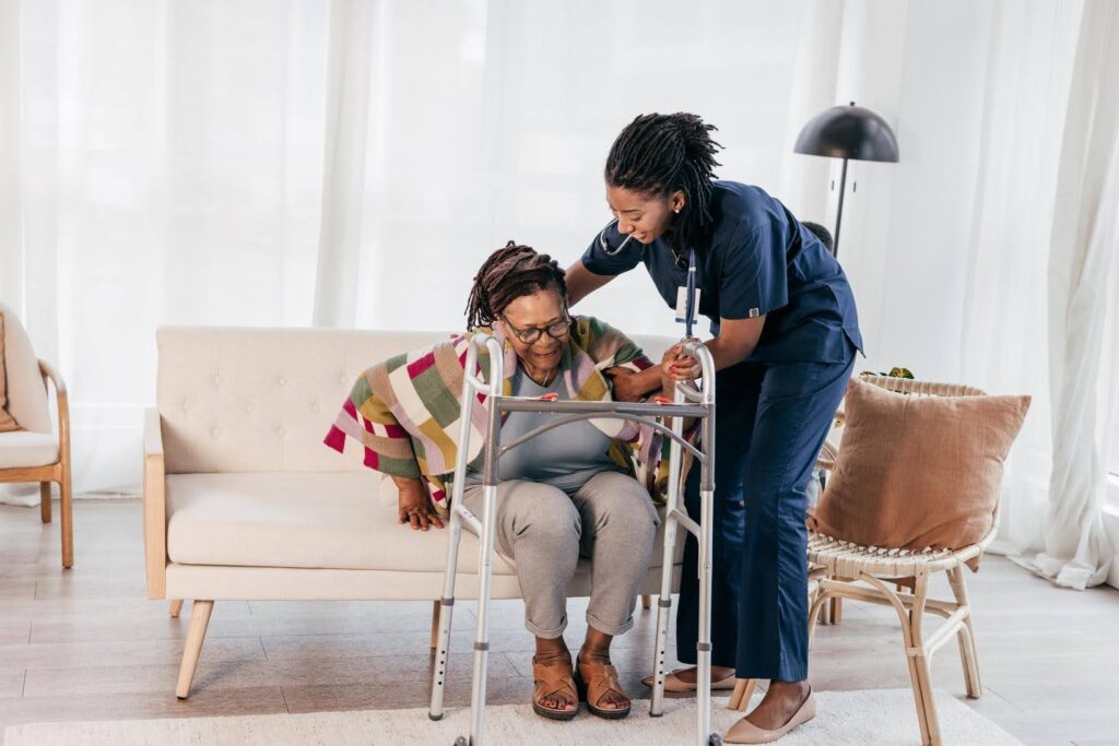 Professional caregiver assisting a senior with mobility, showing that no prior Experience is needed to succeed with Ace Home Care Franchise