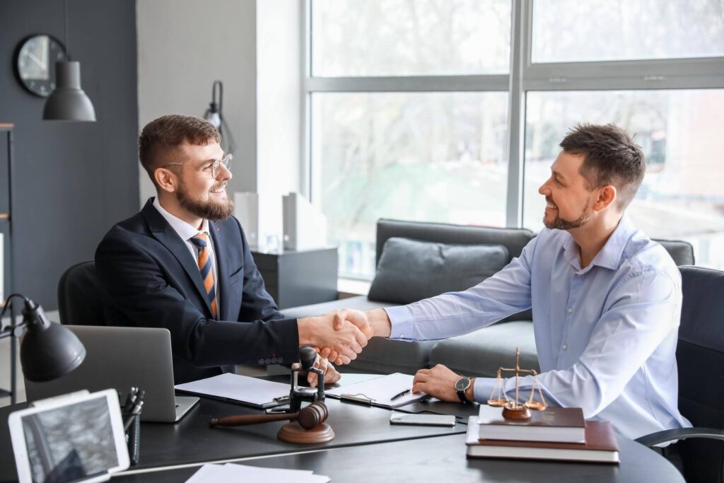 Business owner meeting with an immigration lawyer to discuss E2 visa opportunities, highlighting how Ace Home Care Franchise supports entrepreneurs seeking immigration-friendly senior care businesses.