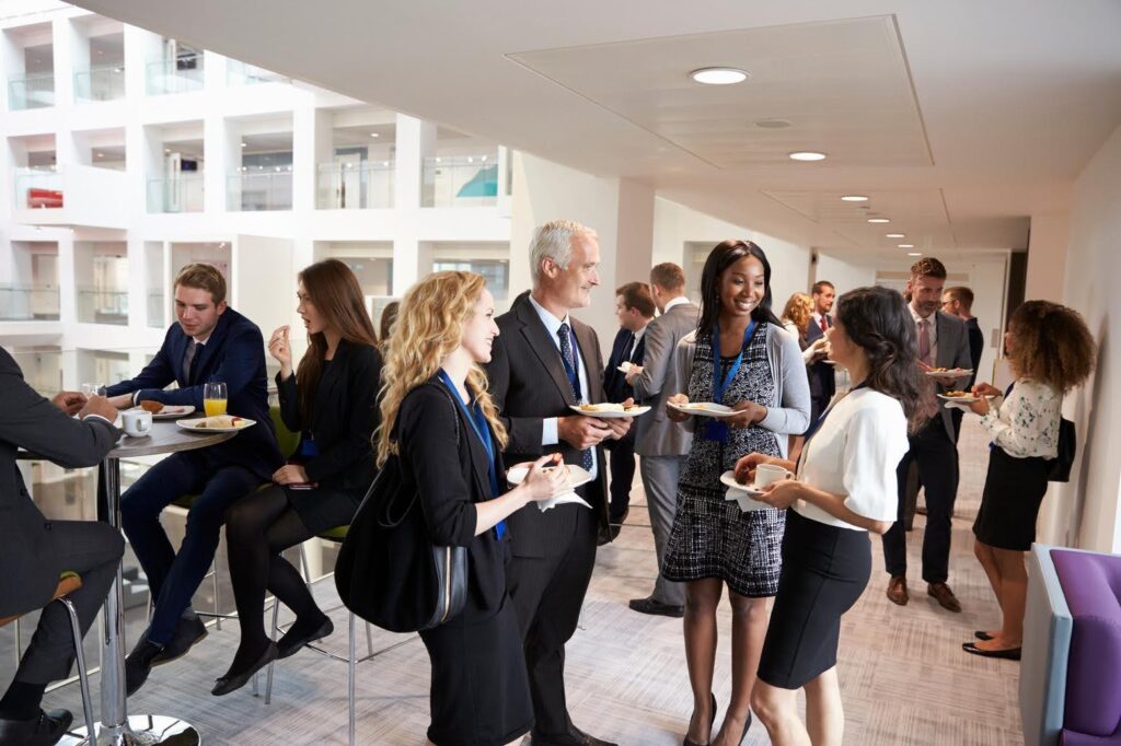 Professionals networking at a local business event, showcasing how Ace Home Care Franchise helps new franchise owners build relationships and grow through local networking events.