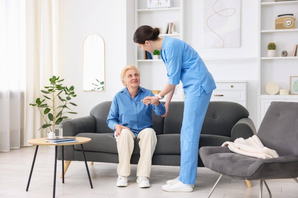 Professional caregiver assisting an older adult at home, showing why investing in an Ace Home Care Franchise remains a recession-resilient business opportunity with growing demand for senior care.
